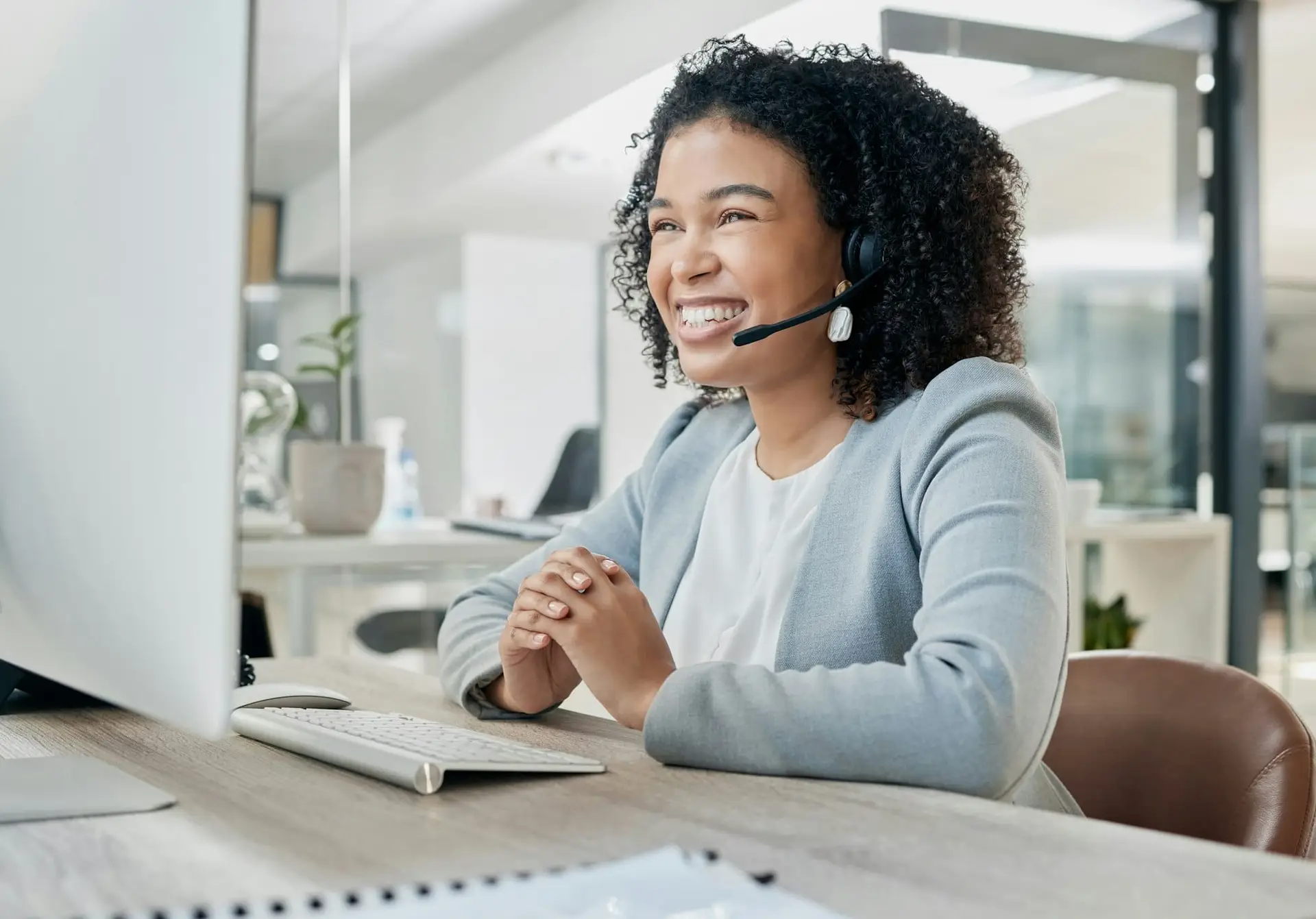 Black woman, call center and computer with CRM and contact us, phone call with customer service or