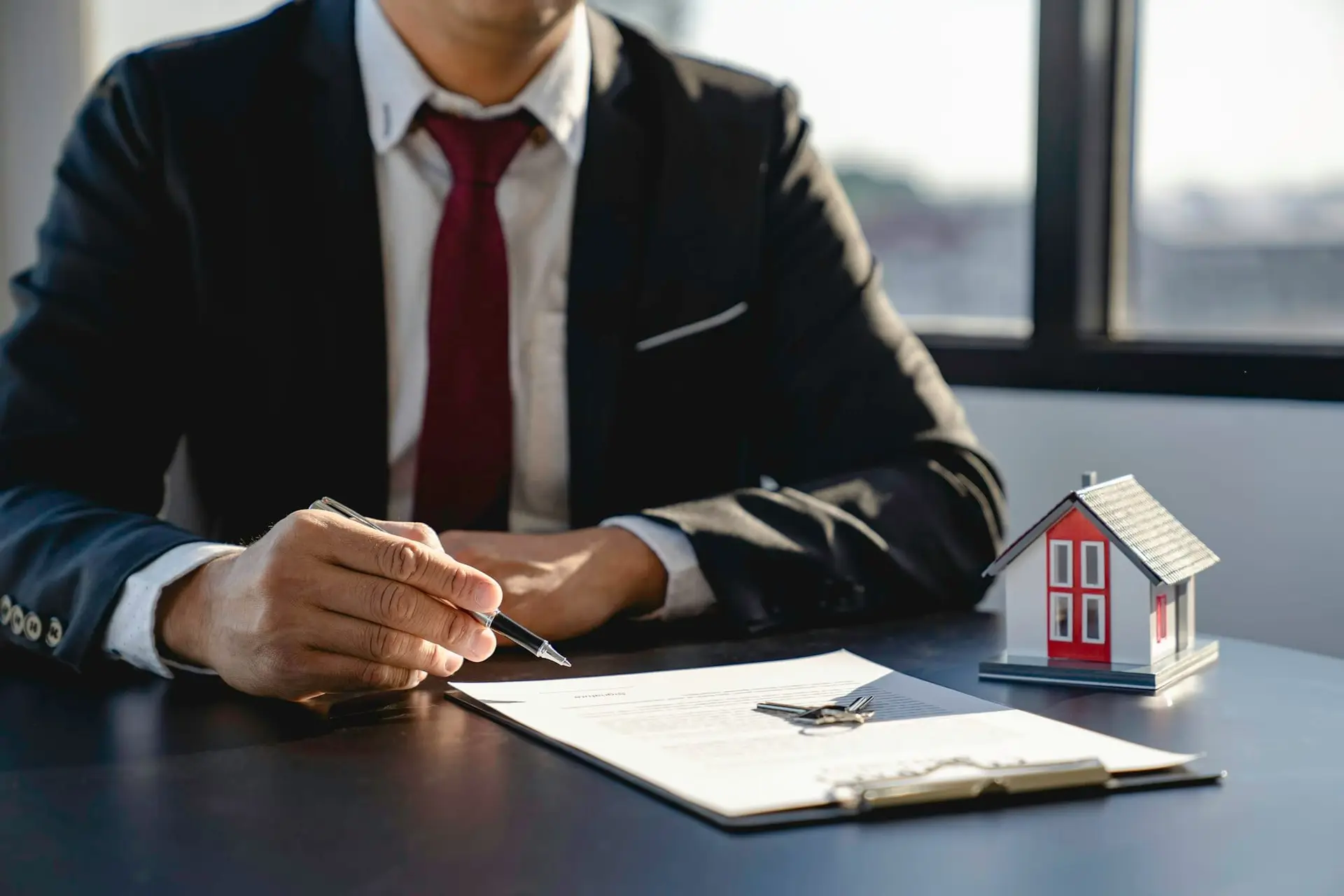 Property sales staff submit land mortgage contract documents to home buyers for sign. discussing for