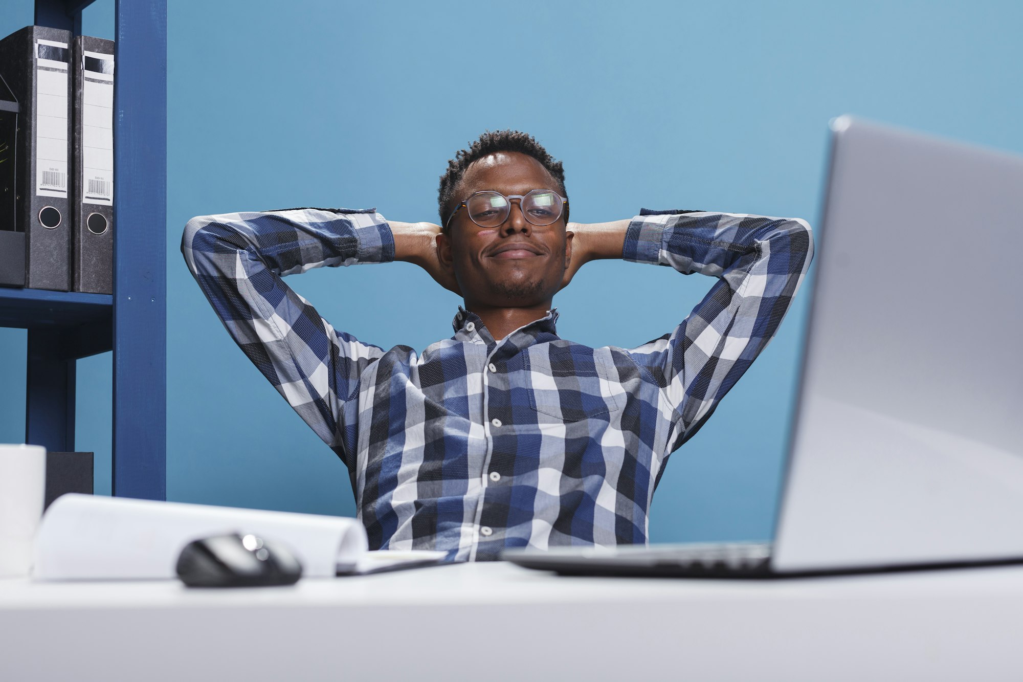 Calm and zen stress free man in company workspace thinking about what to do after work