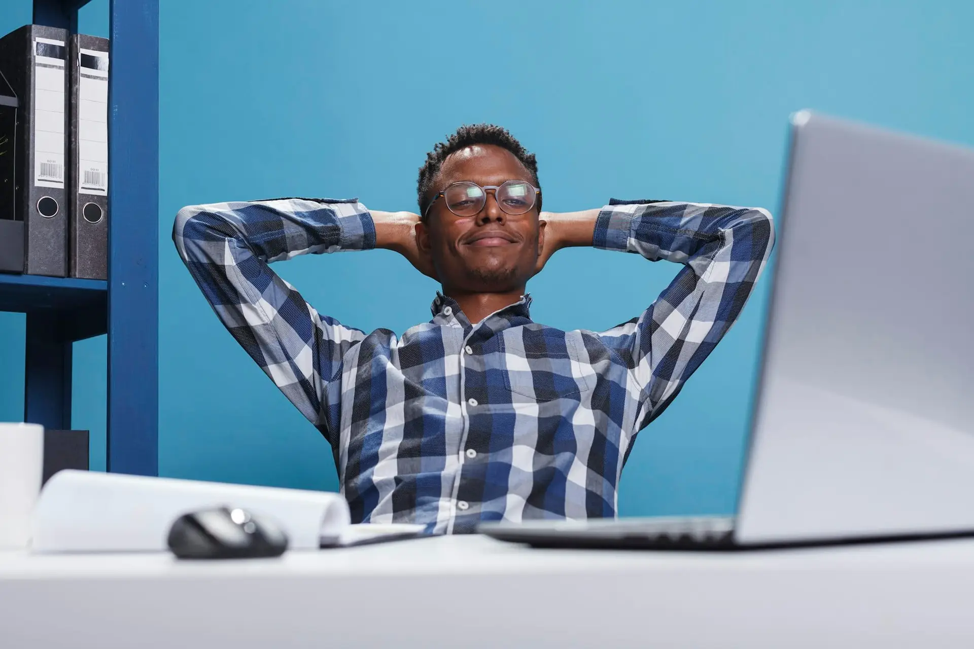 Calm and zen stress free man in company workspace thinking about what to do after work