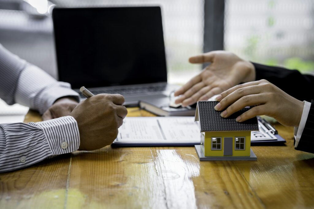 Insurance agent broker man holding document and present pointing showing an insurance policy contrac